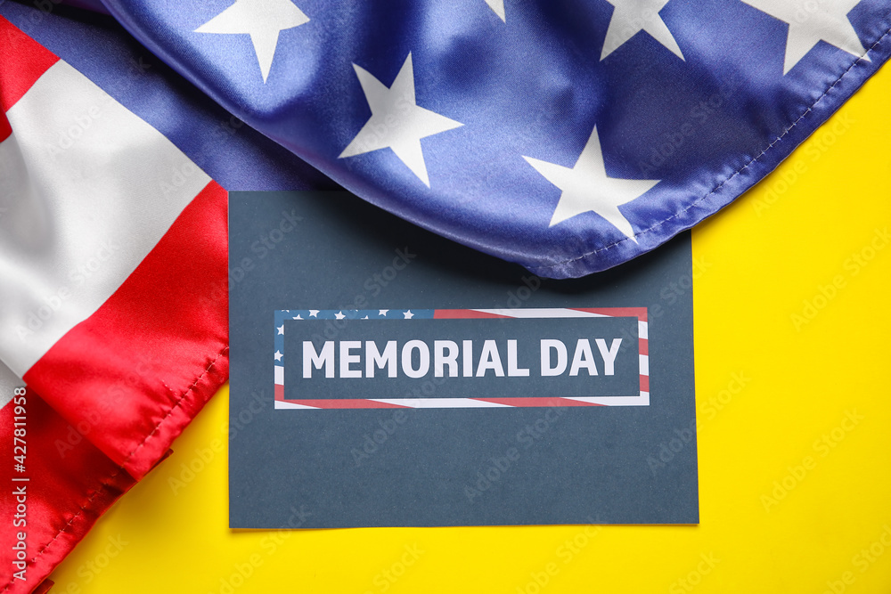 Paper sheet with text MEMORIAL DAY and USA flag on color background