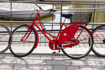 Sticker - Close up view of a red bicycle with metal spokes in the city center of Kiel