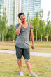 © Spectral-Design - Young asian guy talking on the phone in a park