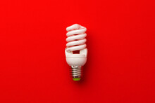 One Light Bulb On Red Background Top View