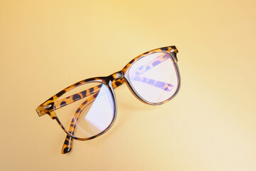 fashion trendy eyes glasses for correcting vision on a creative background, wave from paper, colorful background