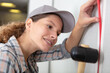 © auremar - tradeswoman installing electrical wiring in building