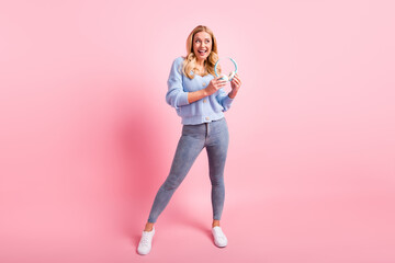 Poster - Full size photo of young happy positive dreamy smiling girl hold headphones look copyspace isolated on pink color background