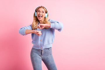 Sticker - Photo of young happy excited smiling positive woman dancing listen music in headphones isolated on pink color background