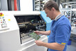 © industrieblick - engineering in microelectronics: workers in the production and quality control  of electronic high tech components in a modern factory