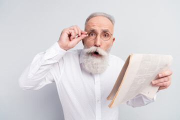 Sticker - Photo of shocked amazed astonished old man wear glasses hold hand newspaper isolated on grey color background