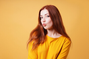 young woman puckering her lips for a kiss or duckface facial expression