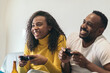 © PEDROMERINO - afro-american couple enjoying playing video game at home. having fun