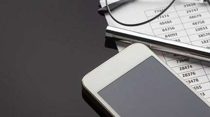 Poster - Office desk table with smartphone ,chart,pen and glassess. Top view with copy space