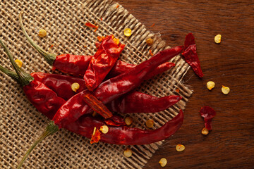 Wall Mural - Macro close-up of Organic red chili pepper( Capsicum annuum)  on wooden top background. Pile of Indian Aromatic Spice. Top view