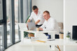 © standret - Two male office workers in formal clothes working together