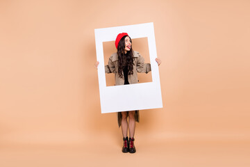 Canvas Print - Full size photo of funny brunette girl hold frame stick out tongue fooling isolated on beige color background