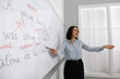 © New Africa - English teacher giving lesson near whiteboard in classroom