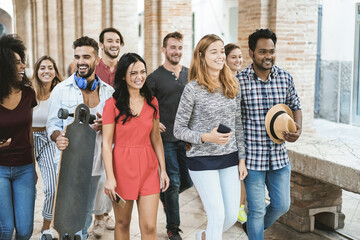 Wall Mural - Happy young friends having fun together outdoors in college university - Main focus in center man face