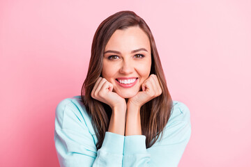 Poster - Photo of adorable attractive young woman hold fists cheeks good mood smile isolated on pink color background