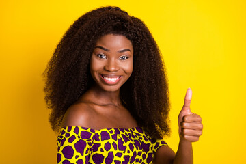 Poster - Portrait of attractive cheerful girl giving thumbup ad cool solution isolated over vibrant yellow color background