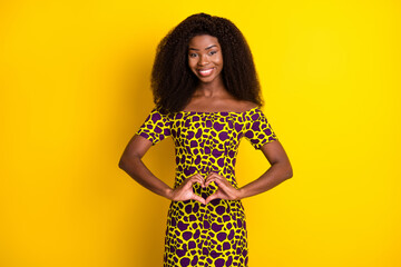 Poster - Portrait of attractive elegant slim cheerful girl showing heart shape isolated over bright yellow color background