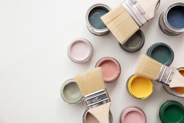 Overhead view of a DIY paint brush with colorful sample paint pots