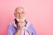Photo portrait of dreamy thoughtful pensioner looking blank space touching chin isolated on pastel pink color background