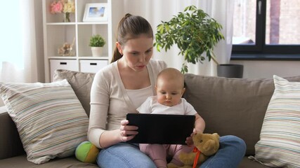 Poster - family, motherhood and people concept - mother with little baby and tablet pc computer at home