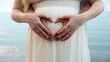 © StockMediaSeller - A young couple shows a heart on the belly of a pregnant woman