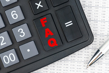 On the table is a report, a pen and a calculator, on the big key of which is written - FAQ