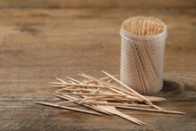 Disposable Toothpicks And Holder On Wooden Background. Space For Text