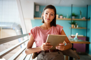 Wall Mural - Portrait of cheerful woman using portable pc for blogging in social networks