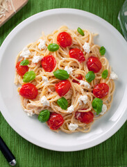 Sticker - Spaghetti with cherry tomatoes and fresh ricotta on a plate.