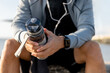 © C_Production - Man runner is holding bottle of water. Tired man is drinking water after run exercise.