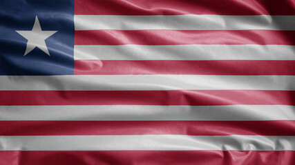 Liberian flag waving in the wind. Close up of Liberia banner blowing soft silk.