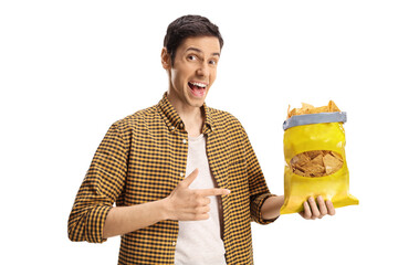 Young man holding a pack of tortilla chips and pointing