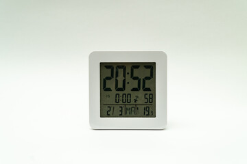 Poster - Closeup shot of a plain white alarm clock showing the time on a clean white background