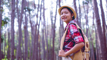 Young Girl At Pine Forest Wear Hat And Red Shirt At Phu Pha Man Khonkaen Thailand.