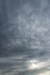 Vertical photo of a majestic gray sky with sun over horizon. No birds, no noise. Sun through stormy clouds.