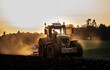 © The Picture Pantry - Ploughing a field at sunset with a tractor and plough, ready for crops on a farm