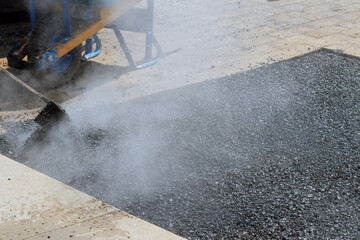 road worker repair asphalt covering new road surface