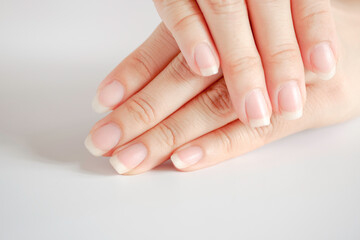 closeup of beautiful hands and fingernails of woman on white background, concept of health care of t