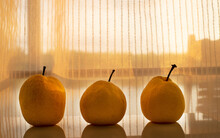 Three Yellow Nashi Pear Fruit Still Life With Sunlight White Curtain Background