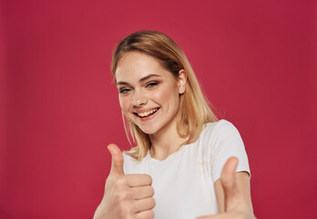 Positive gesture happy blonde red background white t-shirt model