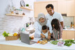 © Odua Images - muslim parent and kids enjoy cooking iftar dinner together during ramadan fasting at home