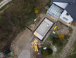 aerial drone shot of pool construction site almost finished spackling from above in a garden