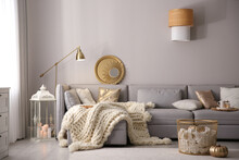 Cozy Living Room Interior With Knitted Blanket On Comfortable Sofa