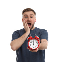 Canvas Print - Emotional overslept man with alarm clock on white background. Being late concept