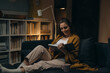 © cherryandbees - woman reading book at home. evening scene