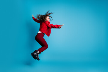 Poster - Full size profile photo of hooray girl jump wear red jacket trousers boots isolated on blue background