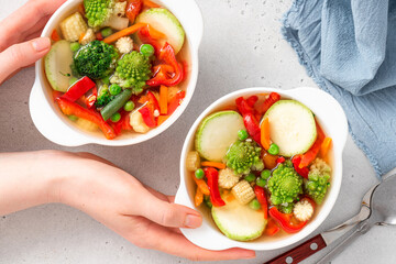 Sticker - Vegetable soup with broccoli, romanesco, pepper, zucchini, and peas in a white bowl. Vegan soup, diet food.