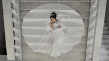 A Bride Lies On The Marble Stairs. A Young Bride In A Magnificent White Dress Is Lying On The Stairs. The Bride In A Beautiful Dress Is Lying On The Marble Stairs In A Theatre Hall.