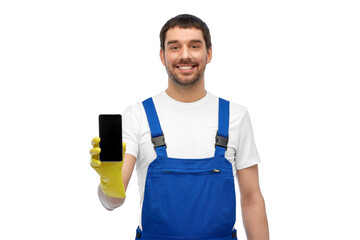 Wall Mural - profession, cleaning service and people concept - happy smiling male worker or cleaner in overall and gloves showing smartphone over white background