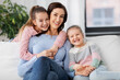 © Syda Productions - people, family and love concept - happy smiling mother with two daughters at home